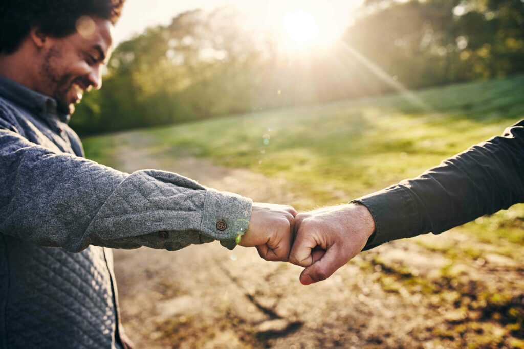 Two men giving each other a friendly punch with their fists